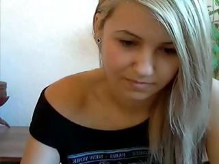 Cute little blonde has a smoke and poses fingering pussy on web camera