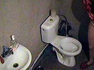 Worthwhile night ritual of sexy blonde in red nighty and slippers caught on spy camera situated in the toilet. The babe sat on the potty and smoked a cigarette having no idea she was obtrusively filmed!
